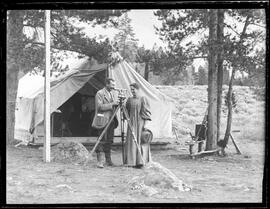 John and Mary Marks with surveying equipment outside a canvas tent