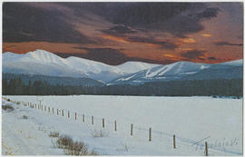 Sunset over snow-capped mountains and a ski area in Colorado