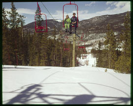 Skiers ride the chairlift at a ski area in Colorado