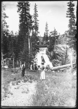 Mary Marks sets up photographic equipment near a waterfall