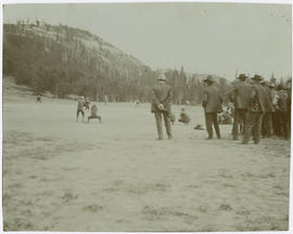 Men watch a baseball game at the Breckenridge ballpark