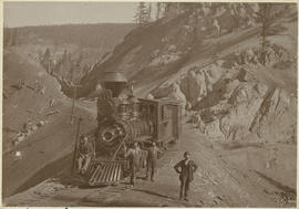 Men pose by the railroad locomotive stopped at Rocky Point, east of Breckenridge