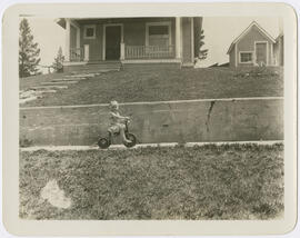 June Kaiser rides her tricycle in front of her family's house in Breckenridge