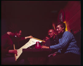 A woman unrolls a scroll in a restaurant in Breckenridge