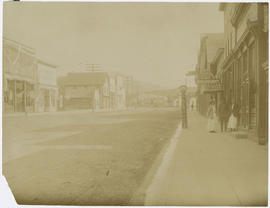 People outside Bruch's Barbershop and Store, view looking south down Main Street in Breckenridge