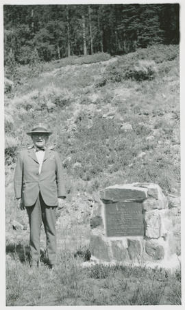 Man stands by the Summit Masonic Lodge No. 2 monument