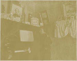 Minnie (Fletcher) Marz plays the upright piano