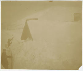 Men shovel snow from the post office on Boreas Pass, east of Breckenridge