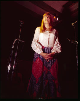 A woman sings on stage in a lounge in Breckenridge