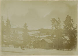 Two boys with a sled in the snowy landscape east of Edwin Carter's log cabin and museum